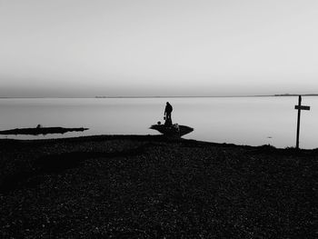 Man on beach against sky