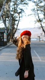 Woman wearing hat standing in snow