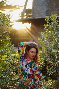 Full length of woman standing against plants