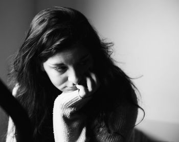 Close-up of woman against wall at home