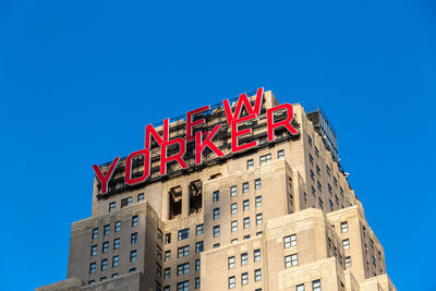 Low angle view of building against clear blue sky