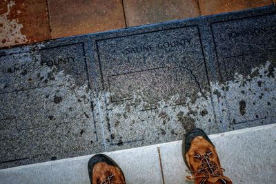 Low section of person standing on sidewalk