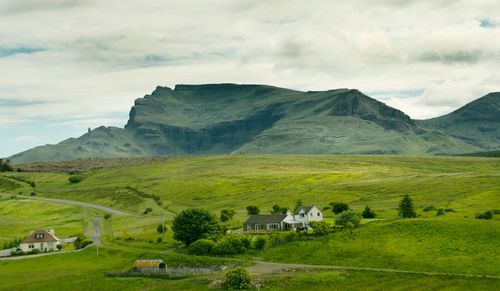 Scenic view of mountains against cloudy sky