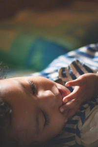 Toddler girl lying on bed at home