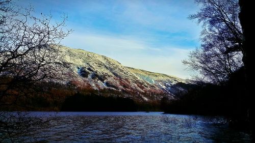 Scenic view of lake against sky during winter