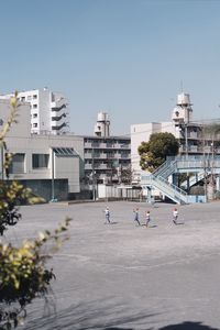 View of buildings in city against clear sky