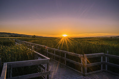 Scenic view of prairie field against sky during sunset