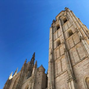 Low angle view of old church against clear blue sky