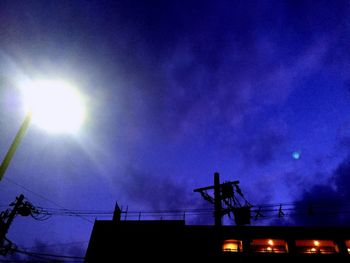 Low angle view of street light against blue sky