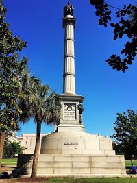 Low angle view of monument against blue sky
