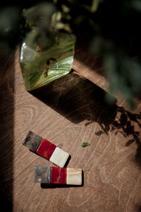 Cropped hand of woman using mobile phone on table