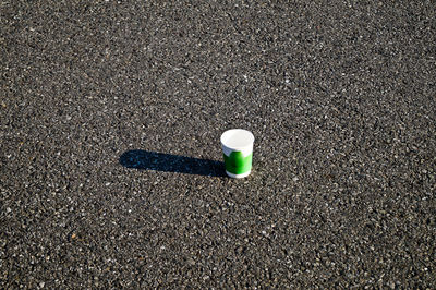High angle view of green disposable cup on road