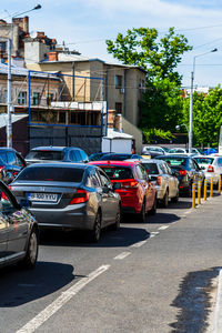 Cars on street against buildings in city