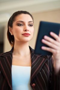 Portrait of young woman using mobile phone
