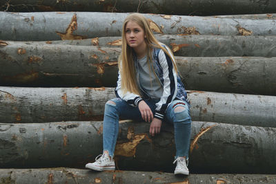 Full length of woman sitting outdoors