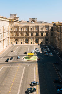 High angle view of cars parked amidst buildings on sunny day