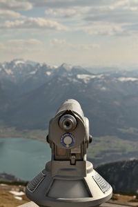 Close-up of coin-operated binoculars against sky