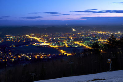 Aerial view of illuminated city against sky at night