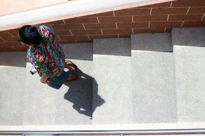 High angle view of woman standing on staircase