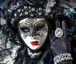 Close-up portrait of woman wearing venetian mask