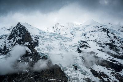 Scenic view of snow covered mountains against sky