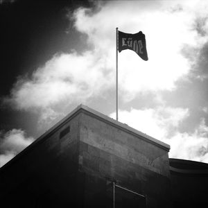 Low angle view of building against cloudy sky