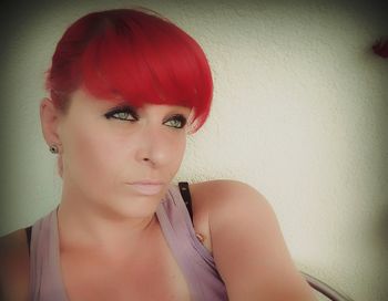 Close-up portrait of young woman against white background