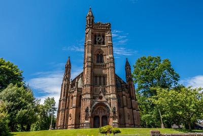 Low angle view of clock tower against sky