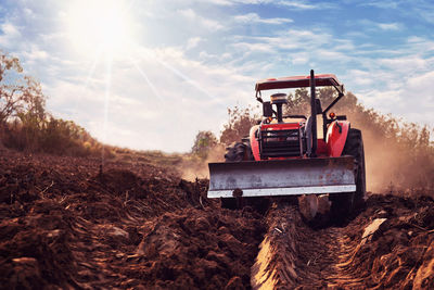 Tractor on field against sky