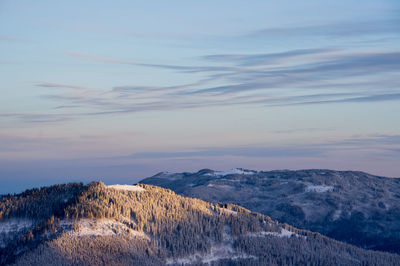 Scenic view of snow capped mountains against sky during sunset