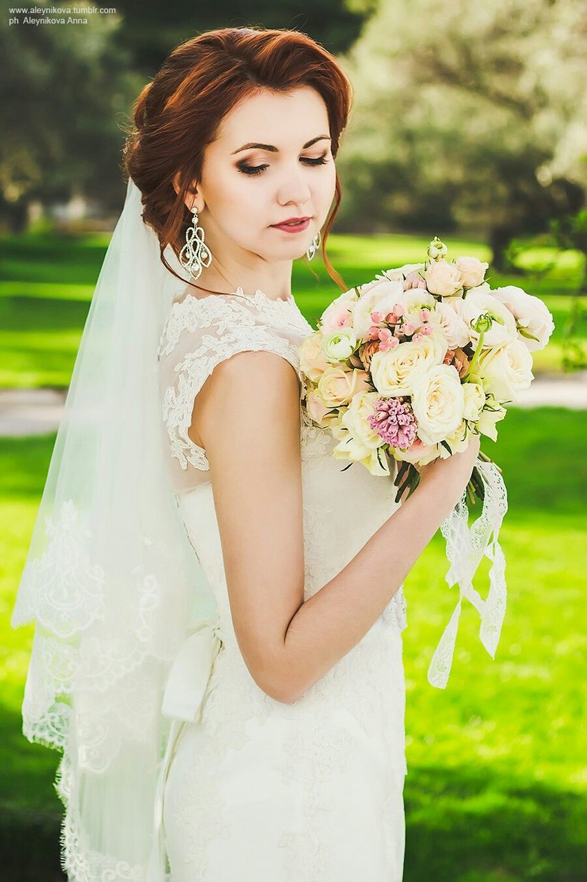 flower, focus on foreground, lifestyles, young women, person, young adult, leisure activity, front view, holding, park - man made space, casual clothing, portrait, standing, close-up, looking at camera, dress, freshness