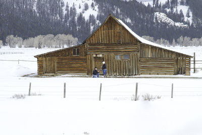 Man standing on snow covered field during winter