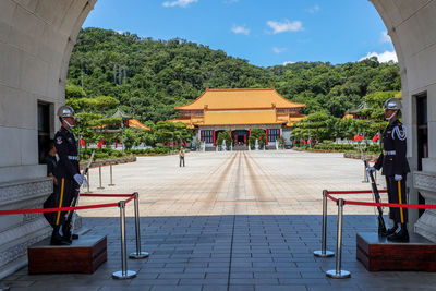 People outside temple against building