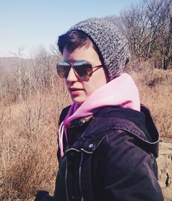 Portrait of man wearing sunglasses on field