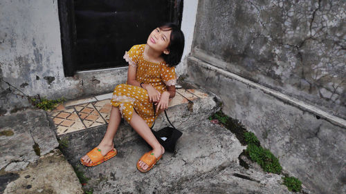 Little girl posing in a backyard with natural background