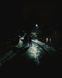 Blurred motion of people walking on road at night