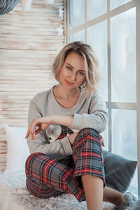 Portrait of woman sitting at home