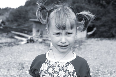 Crying cute little girl with two tails hairstyle