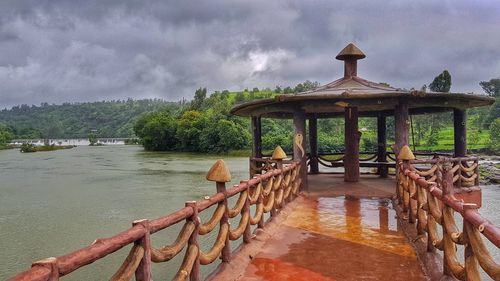 View of bridge over river against cloudy sky