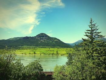 Scenic view of lake by mountains against sky