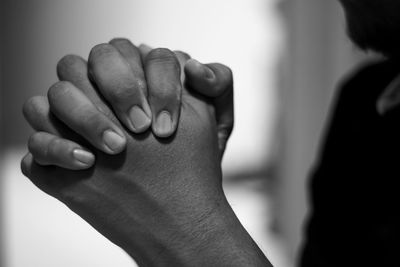 Close-up of woman with hands clasped