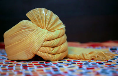 Close-up of wedding turban on table