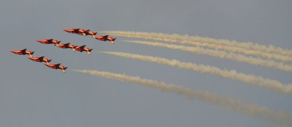 Low angle view of airshow against sky