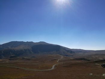 Scenic view of mountains against clear blue sky