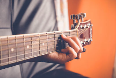 Close-up of hand playing guitar