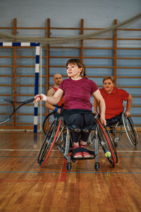 Portrait of young woman sitting on wheelchair