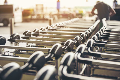 Close-up of shopping cart on bench in city