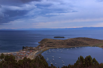 Scenic view of sea by buildings against sky