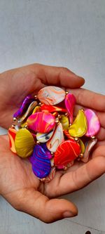 Midsection of woman holding multi colored candies
