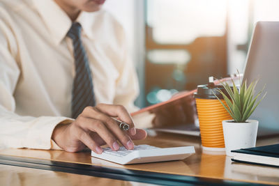 Midsection of businessman working in office